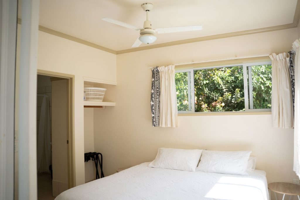 Bedroom 1 with ensuite, ceiling fan and garden view
