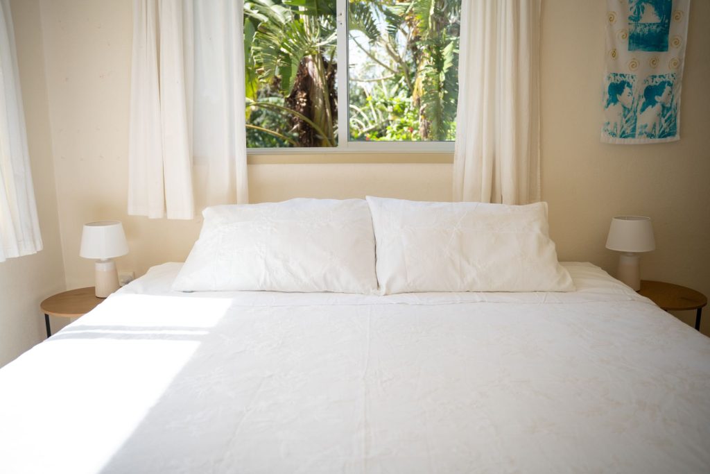 Bedroom 2 with super king bed beneath a garden window